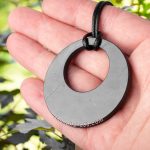 open circle necklace on the hand