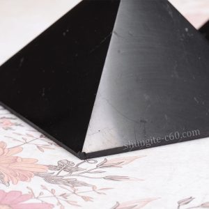shungite pyramid corner close-up with natural chip