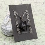 Merkaba crystal necklace on black display card